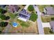 Aerial view of a house with a fenced backyard and a refreshing swimming pool at 32124 Corbin Ridge St, San Antonio, FL 33576