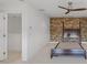 Bright bedroom featuring a ceiling fan and stone accent wall at 212 S Moody Ave # 2, Tampa, FL 33609