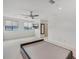 Large bedroom with two windows, a ceiling fan, and a wall-mounted TV at 212 S Moody Ave # 2, Tampa, FL 33609