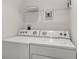 Bright laundry room with washer and dryer and shelving at 212 S Moody Ave # 2, Tampa, FL 33609