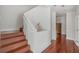 Modern staircase with wood steps and white railings leading to upper level at 212 S Moody Ave # 2, Tampa, FL 33609