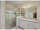 Bright bathroom featuring a walk-in shower, granite vanity, and modern fixtures at 11818 Tetrafin Dr, Riverview, FL 33579