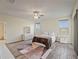 Spacious bedroom with wood-look floors, large windows, and ceiling fan at 11818 Tetrafin Dr, Riverview, FL 33579