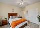 Cozy bedroom with wood furniture and orange blanket at 11818 Tetrafin Dr, Riverview, FL 33579