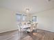 Bright dining room with a white table and chairs, chandelier, and hardwood floors at 11818 Tetrafin Dr, Riverview, FL 33579