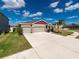 One-story house with a two-car garage and large driveway at 11818 Tetrafin Dr, Riverview, FL 33579