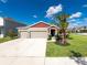 Two-story house with a two-car garage and landscaped lawn at 11818 Tetrafin Dr, Riverview, FL 33579
