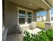 Relaxing front porch with two chairs and well-maintained landscaping at 11818 Tetrafin Dr, Riverview, FL 33579