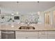 Kitchen island with granite countertops and double sink overlooking the living room at 11818 Tetrafin Dr, Riverview, FL 33579