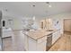 Modern kitchen with a large island, granite countertops, and stainless steel appliances at 11818 Tetrafin Dr, Riverview, FL 33579