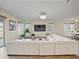 Living area with large sectional sofa, hardwood floors, and a large TV at 11818 Tetrafin Dr, Riverview, FL 33579