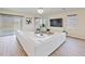 Living room with large sectional sofa, hardwood floors and a large TV at 11818 Tetrafin Dr, Riverview, FL 33579