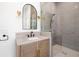 Modern bathroom with a gray tile shower and wood vanity at 3011 W Asbury Pl, Tampa, FL 33611