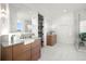 Spa-like bathroom with double vanities, a large shower, and marble floors at 3011 W Asbury Pl, Tampa, FL 33611