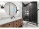 Modern bathroom with a glass shower, white bathtub, and stylish vanity at 3011 W Asbury Pl, Tampa, FL 33611