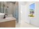Contemporary bathroom with gray tile shower and wood vanity at 3011 W Asbury Pl, Tampa, FL 33611