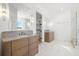 Elegant bathroom with double vanity, patterned floor, and shower at 3011 W Asbury Pl, Tampa, FL 33611