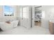 Elegant bathroom with a freestanding tub and marble flooring, next to bedroom at 3011 W Asbury Pl, Tampa, FL 33611