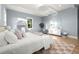 Bright bedroom with light blue walls, hardwood floors, and a comfy bed at 3011 W Asbury Pl, Tampa, FL 33611