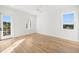Spacious bedroom with hardwood floors, large windows, and private balcony at 3011 W Asbury Pl, Tampa, FL 33611