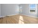 Light-filled bedroom with light gray walls and hardwood floors at 3011 W Asbury Pl, Tampa, FL 33611