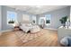 Serene bedroom with light blue walls, hardwood floors, and a comfy bed at 3011 W Asbury Pl, Tampa, FL 33611