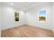 Bright bedroom featuring hardwood floors and large windows with a view at 3011 W Asbury Pl, Tampa, FL 33611
