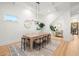 Modern dining room showcasing a statement light fixture and hardwood floors at 3011 W Asbury Pl, Tampa, FL 33611
