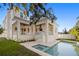 Back exterior showcasing pool, patio, and outdoor kitchen at 3011 W Asbury Pl, Tampa, FL 33611