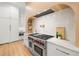 Modern kitchen with a range and white cabinets at 3011 W Asbury Pl, Tampa, FL 33611