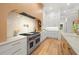 Modern kitchen with white and wood cabinets and a large range at 3011 W Asbury Pl, Tampa, FL 33611