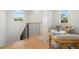 Bright landing area with hardwood floors, modern staircase, and comfortable seating at 3011 W Asbury Pl, Tampa, FL 33611