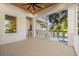 Covered patio with pool view, outdoor kitchen, and ceiling fan at 3011 W Asbury Pl, Tampa, FL 33611