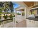 Outdoor kitchen and stairs leading to the pool area at 3011 W Asbury Pl, Tampa, FL 33611