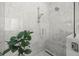 Spa-like shower with marble tile and built-in bench at 3011 W Asbury Pl, Tampa, FL 33611