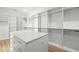 Spacious walk-in closet, white built-ins, light wood floors at 3011 W Asbury Pl, Tampa, FL 33611