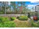 Landscaped backyard with stone fountain and wooden fence at 9527 Pebble Glen Ave, Tampa, FL 33647