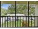 View from screened balcony overlooking parking and grassy common area at 3114 Lake Pine Way # H2, Tarpon Springs, FL 34688