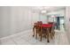 Dining room featuring tile flooring, chandelier, and mirrored wall at 3114 Lake Pine Way # H2, Tarpon Springs, FL 34688