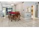 Traditional dining room with tiled floor, ornate wood table, and mirrored wall at 3114 Lake Pine Way # H2, Tarpon Springs, FL 34688