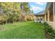 Spacious backyard with lush green grass and mature trees at 5034 Elm Leaf Dr, Brooksville, FL 34601