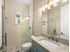 Small bathroom with shower and blue vanity at 5034 Elm Leaf Dr, Brooksville, FL 34601