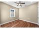 Well-lit bedroom with hardwood floors and a window at 5034 Elm Leaf Dr, Brooksville, FL 34601