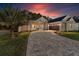 Craftsman style home with paver driveway and landscaped yard at 5034 Elm Leaf Dr, Brooksville, FL 34601