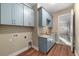 Laundry room with light blue cabinets and a built-in sink at 5034 Elm Leaf Dr, Brooksville, FL 34601
