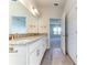 Bright bathroom boasts double vanity with granite countertop and large mirror at 16134 69Th Lane East, Parrish, FL 34219