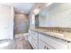Bathroom with granite countertops, white cabinets and a walk-in shower at 16134 69Th Lane East, Parrish, FL 34219