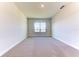 Spacious bedroom with neutral colored carpet and large window at 16134 69Th Lane East, Parrish, FL 34219