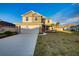 Two-story house with a gray exterior, white garage door, and a landscaped lawn at 16134 69Th Lane East, Parrish, FL 34219