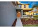 Two-story house with gray siding, orange door and walkway at 16134 69Th Lane East, Parrish, FL 34219